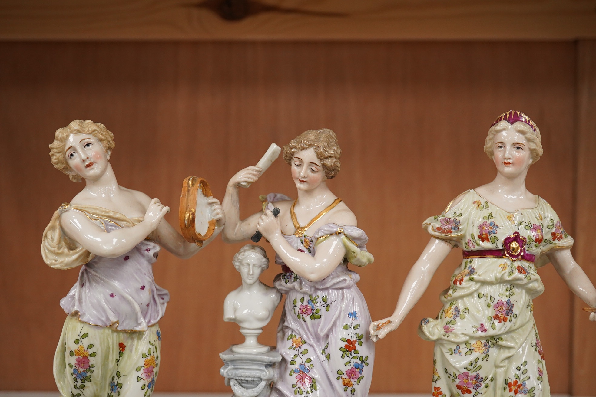 Early 20th century German figural pottery; The Three Graces, tallest 21.5cm high. Condition - restored